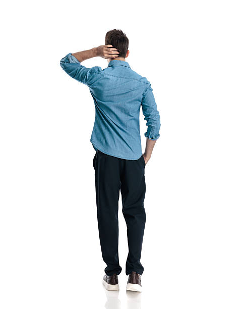 istock confused young man scratching head, wondering and walking with hand in pocket 2217103678