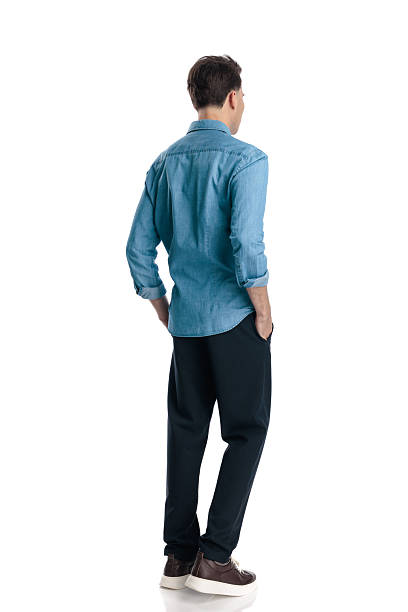 istock side view of young man with hands in pockets walking 2217105056