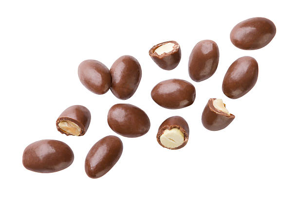 istock Peanuts covered in chocolate and pieces flying close-up on a white background. Isolated 2217106477