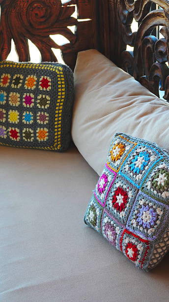 istock Pillows Colorful Closeup Multicolored Cozy Handmade Crochet Textile Decor 2217107498