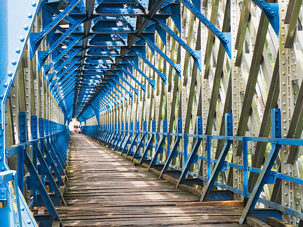 Tasikmalaya, West Java, Indonesia, May 23, 2025: Cirahong Bridge, an old and unique bridge that have iron structure and wood. Using by train at the top and car and bicycle in the bridge.