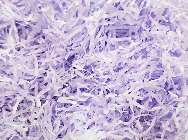 istock Lavender shredded paper background, providing a soft, decorative, and protective material 2217109479