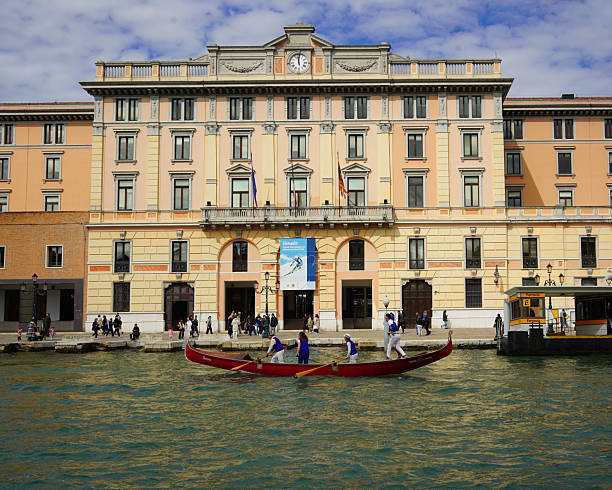 Venice, Italy - 30 March 2025 : Gondolas and river boats are a popular mode of transport for tourists and locals in Venice.