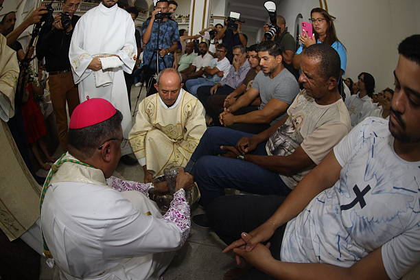 serrinha, bahia, brazil - april 17, 2025: catholic bishop performs the foot washing ceremony during the fogareu procession mission in the city of Serrinha.