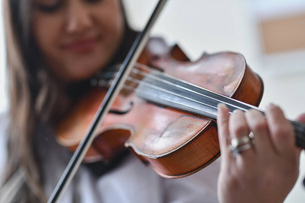 istock Female Violinist Caught In Close-Up Focused On Strings With Steady Elegant Control 2217112933