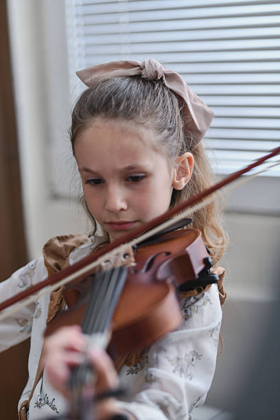istock Beautiful Girl Playing Violin With Serious Expression And Full Concentration On Technique 2217113213