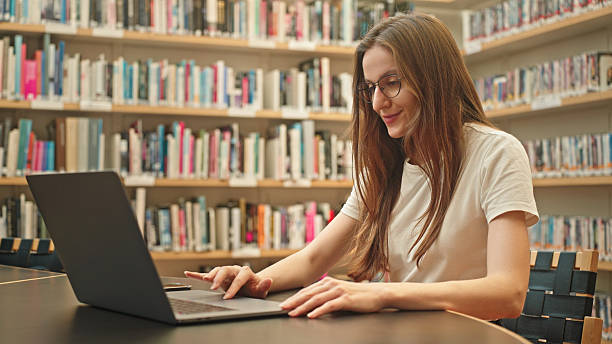 istock A female student types on laptop in a university library. 2217114233