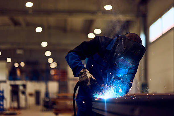 istock Industrial Worker Welding Metal Components in a Modern Factory Setting 2217115017