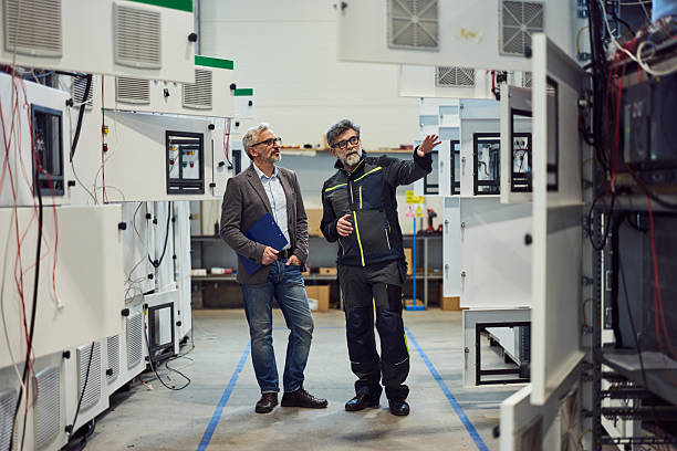 istock Two Professionals Discussing Machinery in Industrial Setting for Production Overview 2217115049