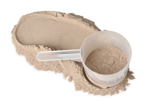 istock Protein powder and scoop isolated on white 2217115790