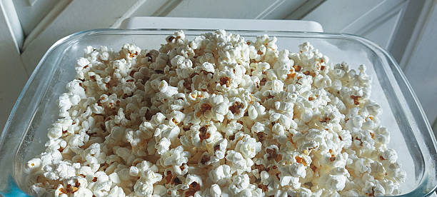 istock Popcorn in a glass box on a white background 2217115989