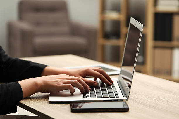 istock Businessman using laptop at wooden table, closeup. Modern technology 2217117367