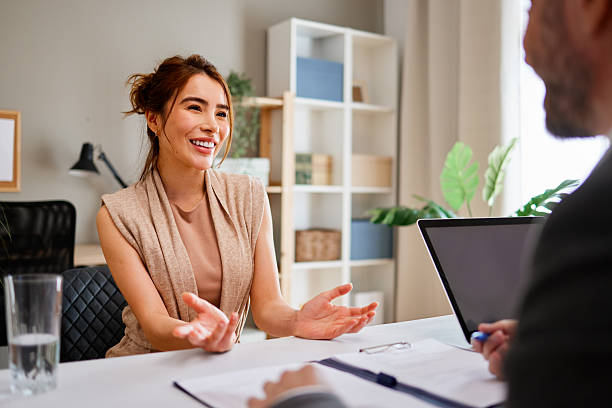 istock Smiling businesswoman gesturing while having a job interview with businessman 2217117714
