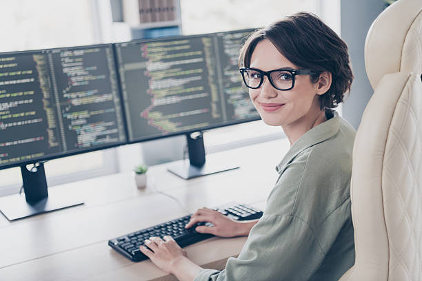 istock Photo of young professional web-designer woman creating new website write scripts coding in office workplace 2217118087