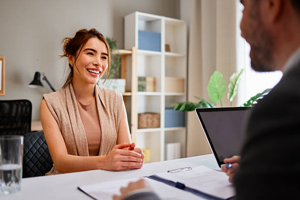 istock Happy applicant smiling during job interview with businessman taking notes on laptop 2217118351