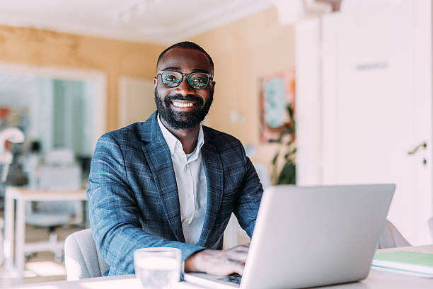 istock Successful businessman in modern office working on laptop. 2217119331
