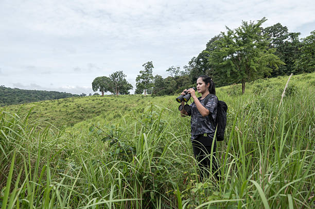 istock Female birdwatching/hiking  in nature concept 2217120451