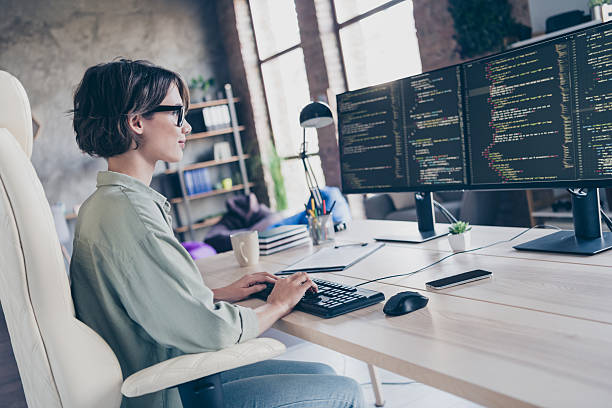 istock Profile side view portrait of nice smart skilled girl senior manager typing code html css cyber security at workplace workstation indoors 2217121200