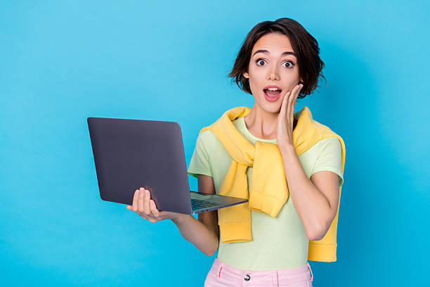 istock Photo of cute impressed lady dressed yellow pullover reading modern gadget arm cheek isolated blue color background 2217121610