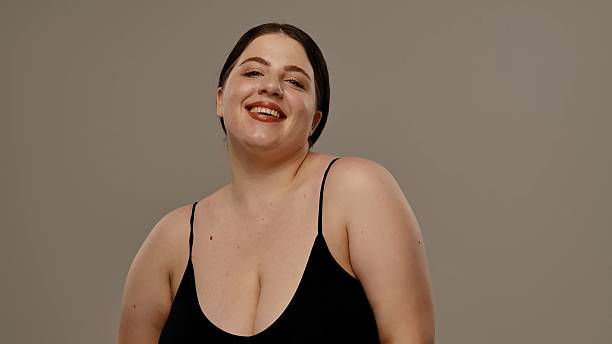 istock Confident Woman Smiling Against Simple Background 2217128291