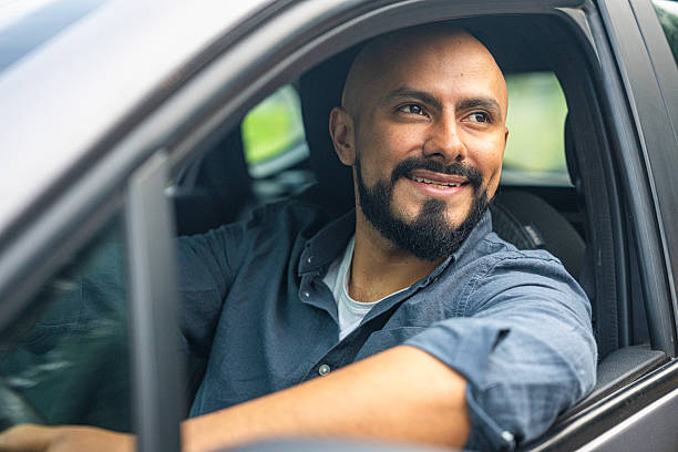 istock Latin American man looking out the window while driving his car. 2217128548