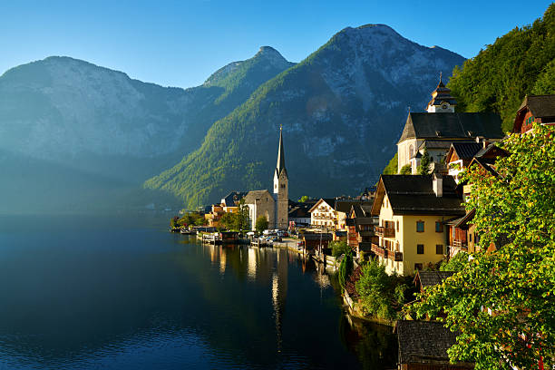 Blue sky and morning mist at beautiful Hallstatt village on Hallstatter Lake in the Austrian Alps in the region of Salzkammergut, Austria.