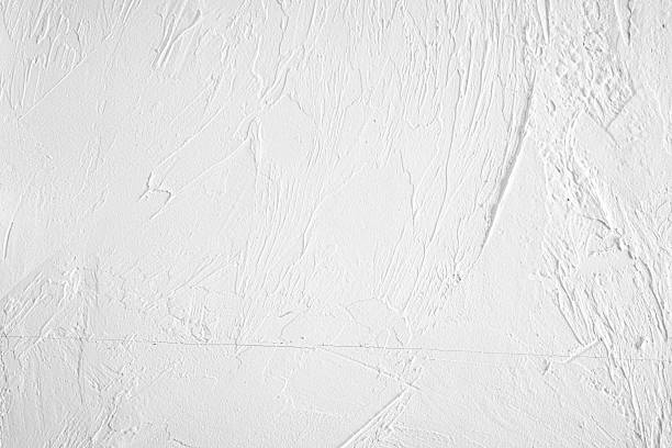 istock Textured white wall with subtle details reflecting light and shadow play 2217130104