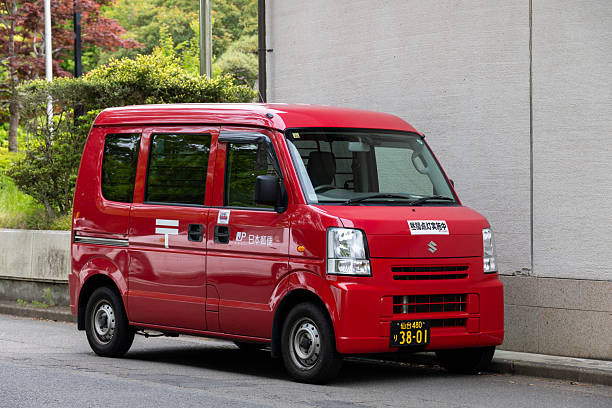 Side view of a red truck in motion on a road