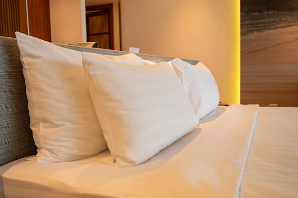 Relaxing hotel room setup with plush pillows modern interior cozy ambiance close-up view