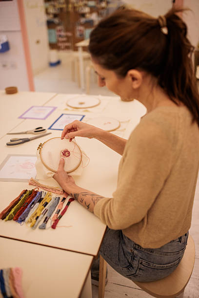 istock Crafting Enthusiast Doing Embroidery in Her Workshop 2217138611