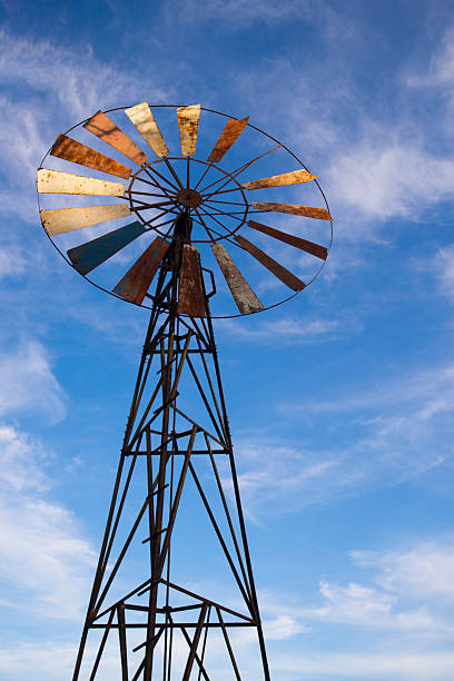 istock Old windmill against a blue sky with white clouds, close-up 2217141885