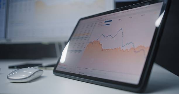 istock Digital Tablet and Computer with Multi-Monitor Desktop System Displaying Online Trading Software 2217143097