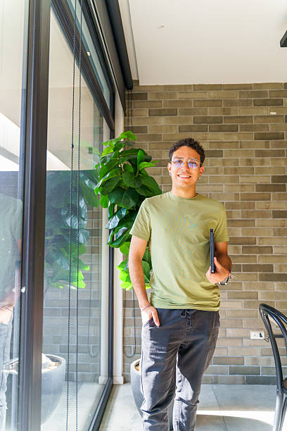 istock Latin american freelancer smiling and holding tablet in coworking space 2217144532