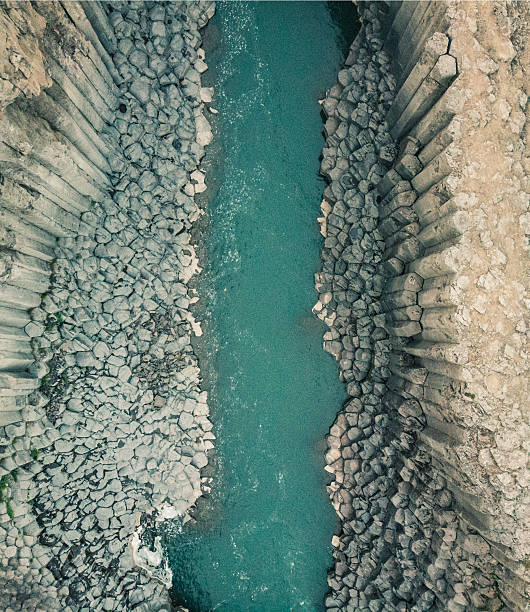 istock Aerial view of turquoise river slicing through basalt columns, Studlagil Canyon. 2217144571