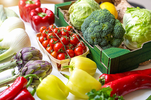 istock Fresh organic farm vegetables in boxes on table 2217145029