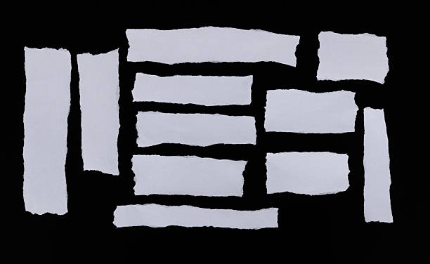 istock Pieces of torn paper on black background 2217145504