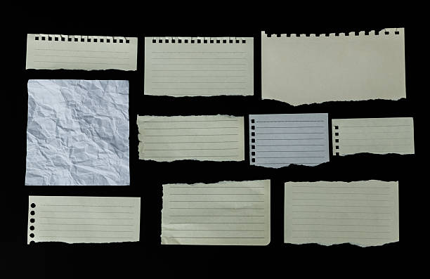 istock Many pieces of lined paper on black background 2217145514