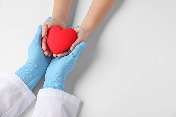istock Doctor and child holding heart model on white background, top view. Space for text 2217146175
