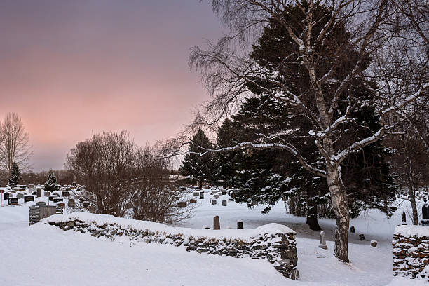 istock Snow on a cemetery and pink sky, Norway 2217146220