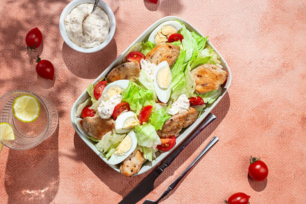 istock Caesar salad with chicken in a white plate on the table. Healthy breakfast. Dinner 2217146281