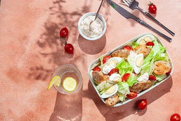 istock Caesar salad with chicken in a white plate on the table. Healthy breakfast. Dinner 2217146365
