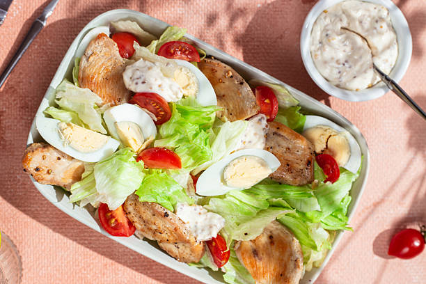 istock Caesar salad with chicken in a white plate on the table. Healthy breakfast. Dinner 2217146368