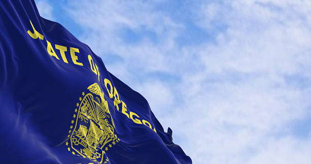 istock Oregon state flag waving in the wind on a clear day 2217147549