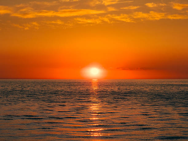 istock Orange Cast Of The Sunlight Over The Ocean 2217150029