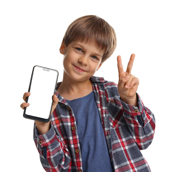 istock Cute little boy with smartphone showing peace sign on white background 2217151501