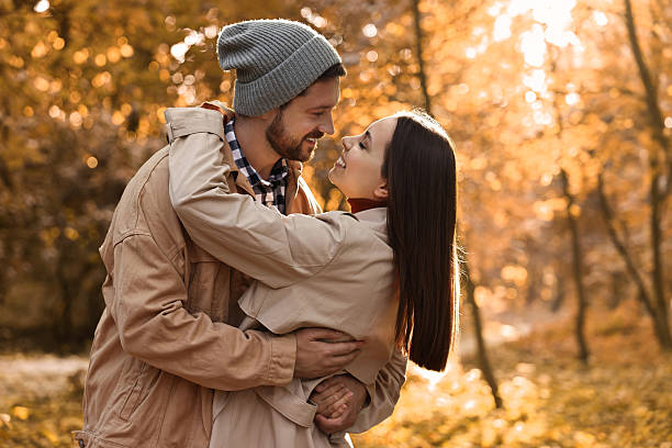 istock Beautiful couple spending time in park on autumn day 2217152976