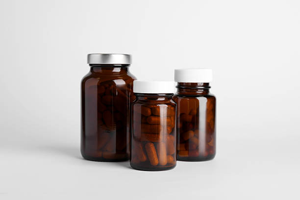 istock Medical bottles with pills on white background 2217153747