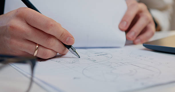 istock Top view. Close up. architect hands designer working drawing lies and the computer stands with architectural scheme on blueprint in workroom. Concept of a workflow on a new project 2217153858