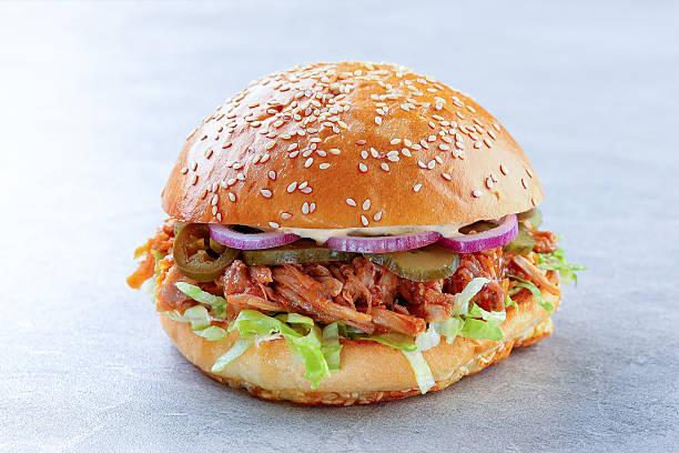 istock Juicy Pulled Pork Sandwich Layered with Fresh Lettuce and Pickles 2217155377