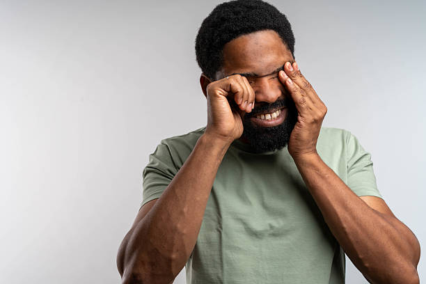 istock Sleepy and tired man rubbing his eyes 2217156306